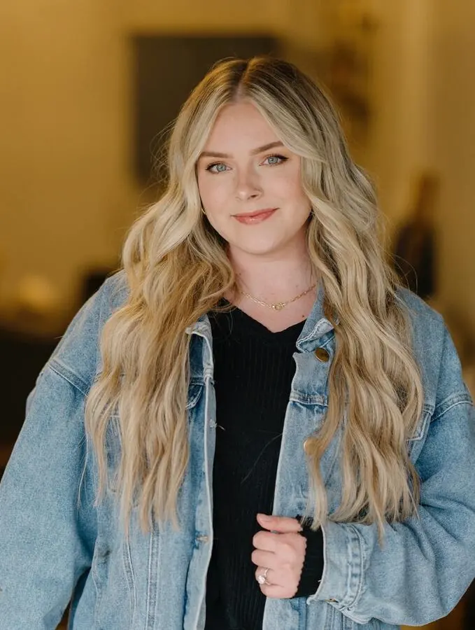Guest in a denim jacket with long blonde hair