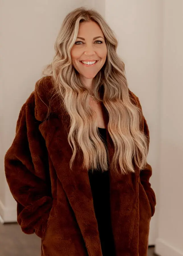 Guest in a brown coat with long blonde hair